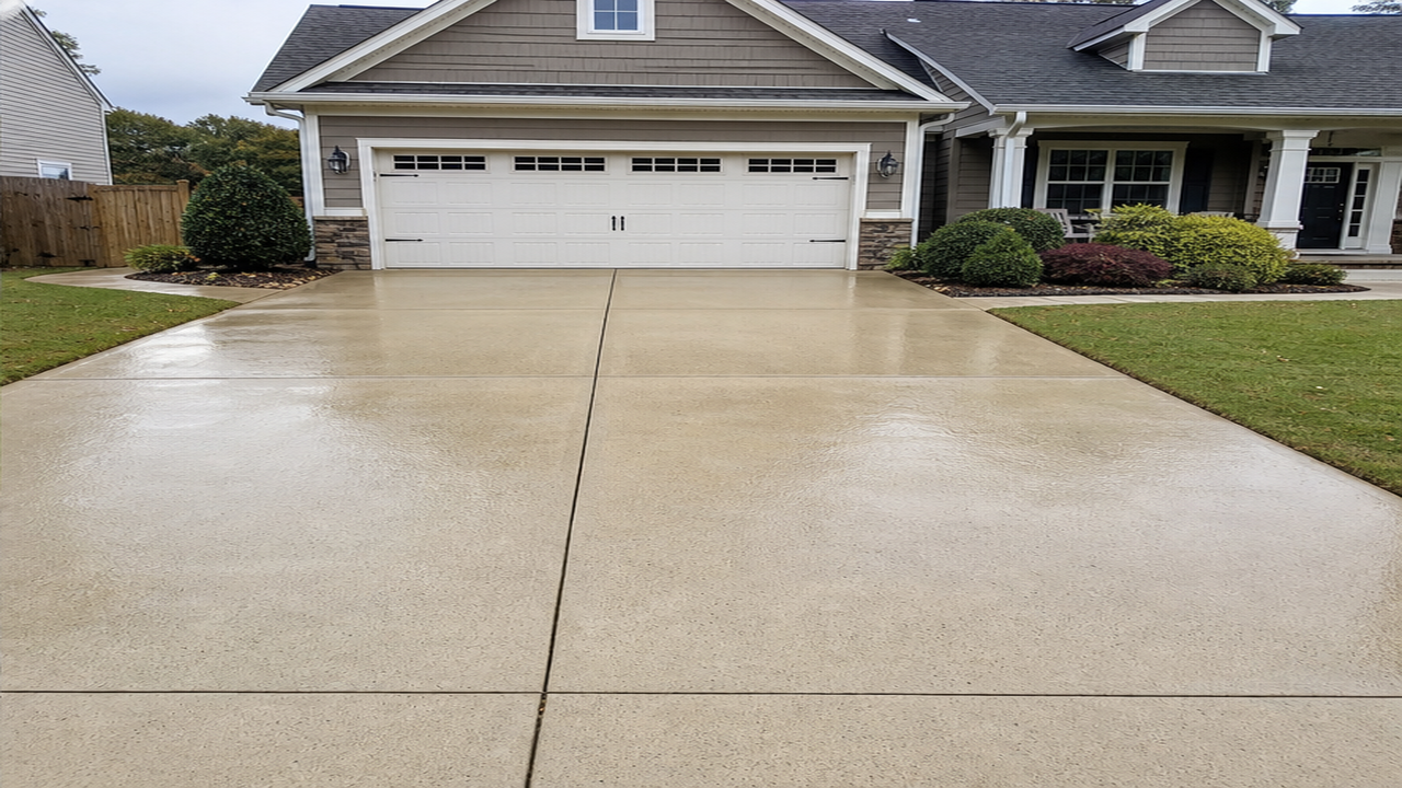 Clean wet concrete driveway after pressure washing