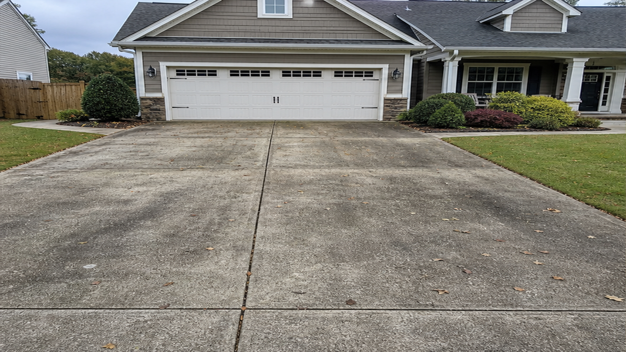 Weathered concrete driveway before pressure washing